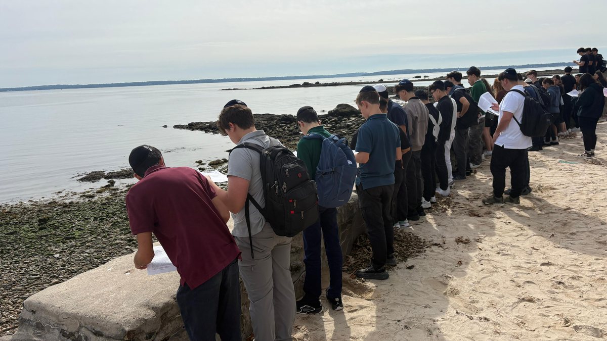 WHHS students gathered along the shoreline of the Long Island Sound