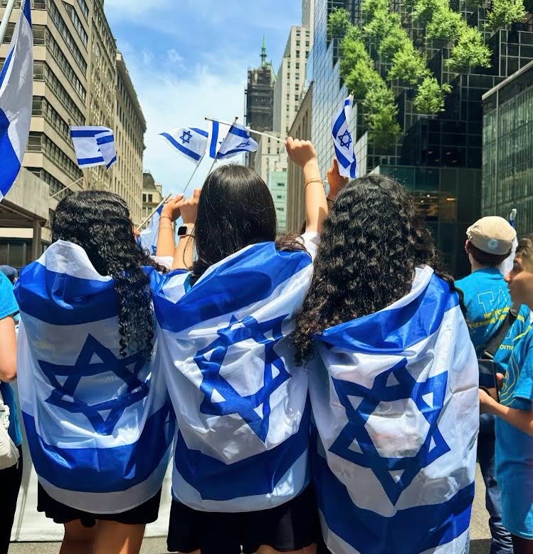WHHS students at the Israel Day Parade draped in Israeli flags